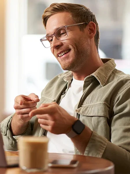 Man smiling and pointing at a computer